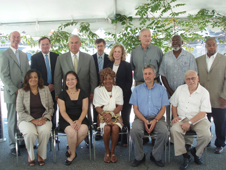 Mayor and City representatives pose with Green Housing Program recipients